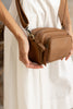 Remi crossbody bag - Camel brown Pebble-Baleka Leather-Chic, compact & endlessly versatile. The Remi is our most versatile and practical bag - thoughtfully designed to keep up with your day. Featuring a front compartment for your must-have essentials, a sleek back pocket with secure press stud closure and a spacious main compartment complete with an internal zip pocket and slip pocket for a neat interior layout. Fully lined and finished with an adjustable strap that can be worn on the shoulder or crossbody,