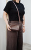 Remi crossbody bag - Chocolate Pebble-Baleka Leather-Chic, compact & endlessly versatile. The Remi is our most versatile and practical bag - thoughtfully designed to keep up with your day. Featuring a front compartment for your must-have essentials, a sleek back pocket with secure press stud closure and a spacious main compartment complete with an internal zip pocket and slip pocket for a neat interior layout. Fully lined and finished with an adjustable strap that can be worn on the shoulder or crossbody, 