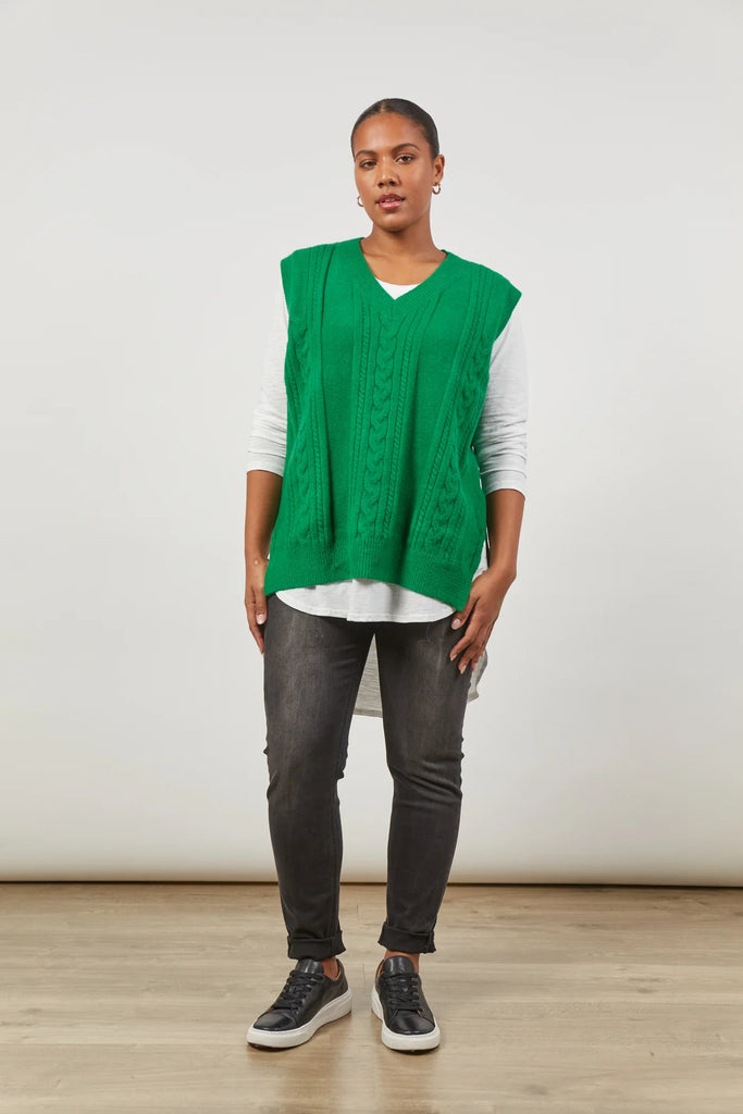 Renew Vest - Meadow-Isle of Mine-One vest. Endless possibilities. The oversized fit of the Renew Vest, crafted from a blend of wool and recycled knit, promises enduring versatility across seasons. With a v-neck, sleeveless design, and woven cable detailing, this vest effortlessly adds sophistication. Whether tucked into trousers or layered over a linen shirt, embrace the countless opportunities this vest brings for timeless and stylish ensembles. FEATURES: V-Neck Sleeveless Woven cable design Hip-length fit