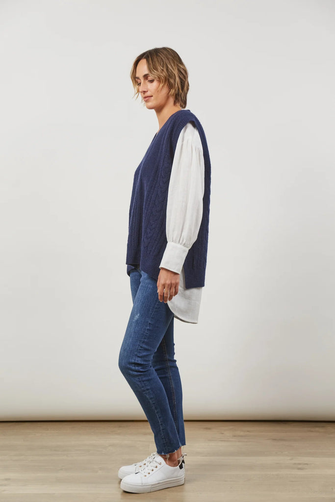 Renew Vest - Twilight-Isle of Mine-One vest. Endless possibilities. The oversized fit of the Renew Vest, crafted from a blend of wool and recycled knit, promises enduring versatility across seasons. With a v-neck, sleeveless design, and woven cable detailing, this vest effortlessly adds sophistication. Whether tucked into trousers or layered over a linen shirt, embrace the countless opportunities this vest brings for timeless and stylish ensembles. V-Neck Sleeveless Woven cable design Hip-length fit Side ve