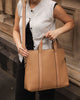 Rhodes laptop bag - latte-Louenhide-The Louenhide Rhodes Latte Laptop Bag is a spacious and stylish work tote and a Louenhide classic. Season on season, this computer bag is a customer favourite. Invest in this practical and structured, quality vegan leather Louenhide laptop bag, perfect for work, university or school. Spacious enough to fit up to a 15-inch laptop, with plenty of room for notebooks, pens, and books. Wear comfortably on your shoulder with the adjustable and detachable strap. Extra padding an