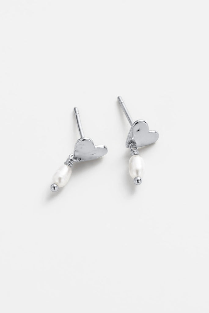 Romy drop earring - silver-Zarla-A softly sculpted silver heart, finished with a delicate pearl drop. This piece brings a light, coastal feel with a touch of understated elegance. Effortless, feminine, and made for everyday wear. *Rhodium Plated Solid Brass Base *Water proof: Can be worn in the ocean or pool-Pash + Evolve