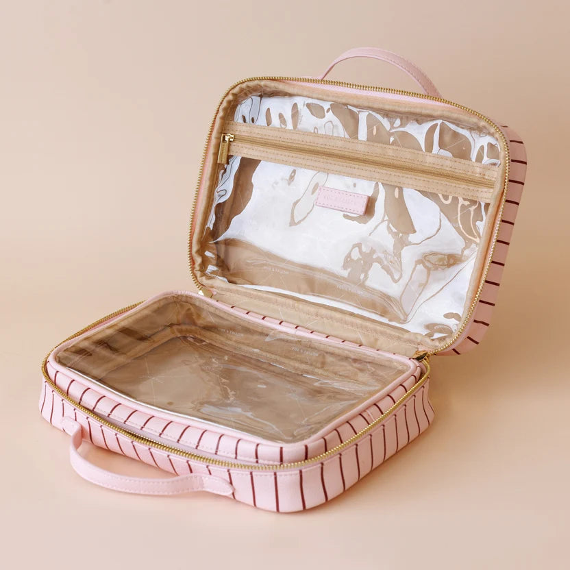 Rosé Pinstripe Cosmetic Bag-Fox & Fallow-The bag of your dreams is here! With so many bonus features, you’ll be wondering where they’ve been all your life. The miracle pop out bag everyone’s been talking about. The ingenious removable clear bag is the true MVP here: it pops out of the main bag and it’s perfect for all your makeup & skincare essentials so you can find them easily through the clear plastic sides. Take it out and use it for your daily makeup & skincare routine or separately at airport securit