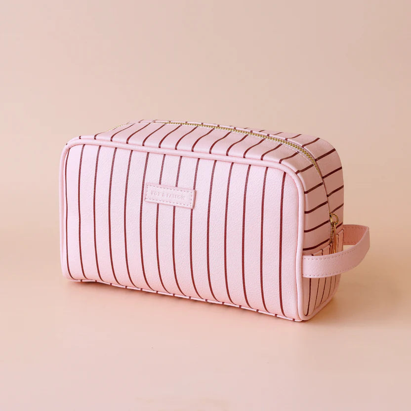 Rosè pinstripe wash bag-Fox & Fallow-The bag of your dreams is here! With so many bonus features, you’ll be wondering where they’ve been all your life. Beautiful, but practical. Perfect as an everyday make up bag or for all your bathroom essentials for the next work trip or vacay. Crafted from super soft, yet durable luxury pebble vegan leather it's easy to keep clean - simply wipe down with a damp cloth. The monogrammed tan lining is designed to hide make up or spills but also makes it easy to find all yo