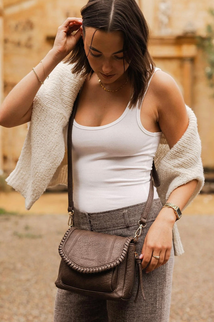 Shania Crossbody Bag - Chocolate-Louenhide-The Louenhide Shania Chocolate Crossbody Bag is the epitome of elevated style that complements your everyday ensemble. Available in a range of seasonal neutrals, this trending casual women's crossbody bag features a subtle woven vegan leather trim that adds a touch of effortless sophistication to your year-round capsule wardrobe. With a spacious and organised interior that fits your everyday essentials, you can keep your belongings safe with the magnetic clasp flap