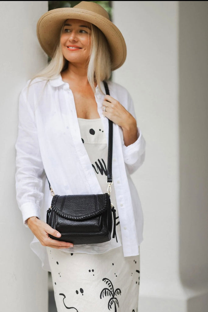 Shania crossbody bag - black-Louenhide-The Louenhide Shania Crossbody Bag is the epitome of elevated style that complements any summer ensemble. Available in a range of timeless summer neutrals, this casual women’s crossbody bag features a subtle woven vegan leather trim that adds a touch of effortless sophistication to your summer capsule wardrobe. With a spacious and organised interior that fits your everyday essentials, you can keep your belongings safe with the magnetic clasp flap closure. With its soft