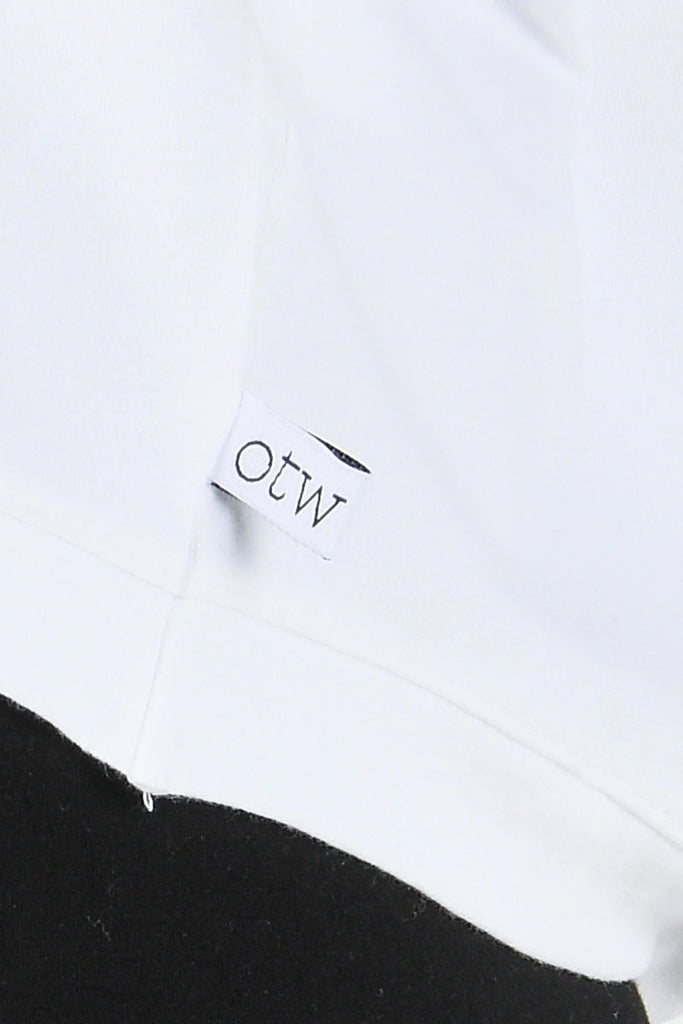 Shell Tee - White-One Ten Willow-Features: Round neckline Curve hemline Short sleeve Fabrication: 95% Cotton 5% Elastane The women's shell tee is a modern, versatile wardrobe essential. It has a clean, minimalist design with a flattering round neckline that sits comfortably at the collarbone, offering a relaxed yet polished look. The short sleeves add just the right amount of coverage, ideal for layering or wearing solo in warmer weather. Its curved hemline is slightly longer at the back, creating a soft, f