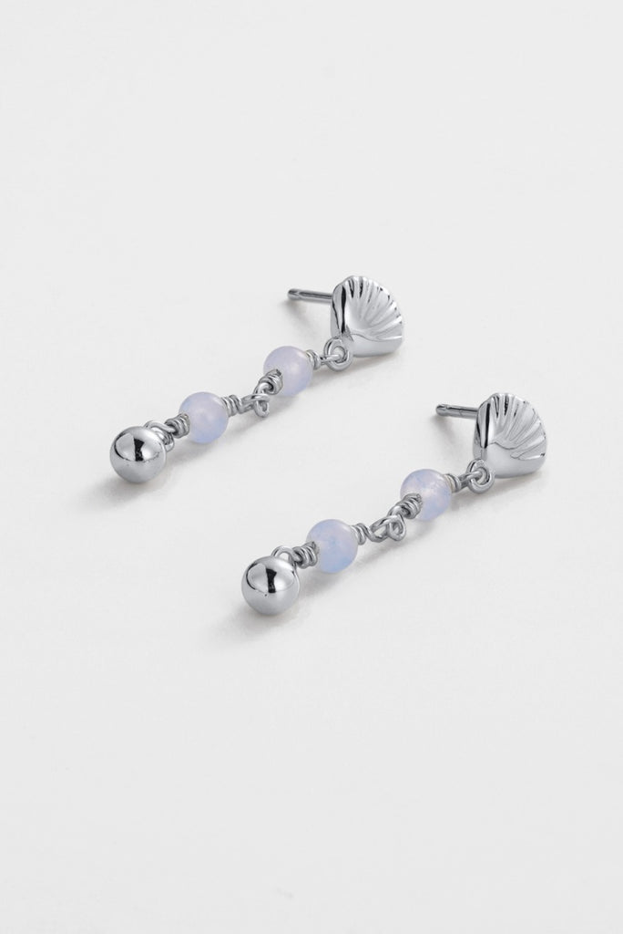 Shelly drop earring - silver-Zarla-A delicate drop earring featuring a sculpted shell detail with soft tonal accents. Light-catching and full of gentle movement, it brings a cool, luminous feel to your look. Feminine, effortless, and easy to wear. *Rhodium Plated Solid Brass Base *Water proof: Can be worn in the ocean or pool-Pash + Evolve