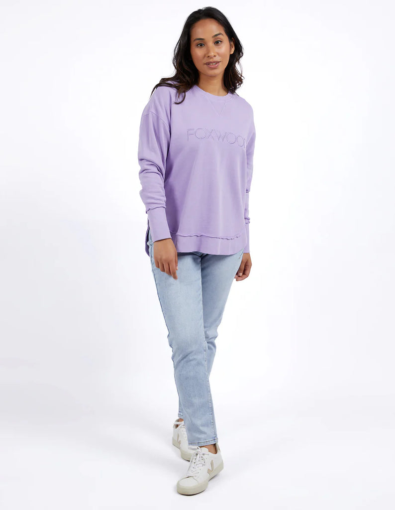 Simplified Crew - Lavender-Foxwood-The Simplified Crew is the perfect throw over for your everyday wardrobe. With its round neck, hi-lo hemline, side splits with raw edging & the classic Foxwood logo, you are going to want one in every colour. Front chest embroidery Raw edge detail Curved hem 100% Cotton Model is wearing a size 10-Pash + Evolve