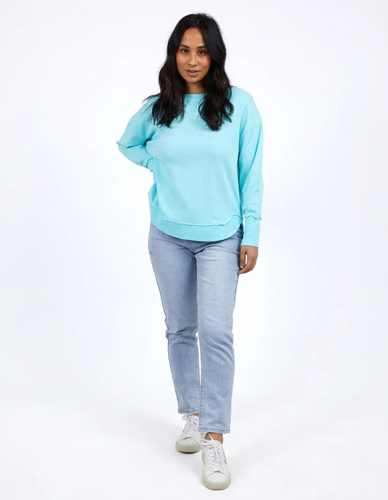 Simplified Crew - Light Blue-Foxwood-The Simplified Crew is the perfect throw over for your everyday wardrobe. With its round neck, hi-lo hemline, side splits with raw edging & the classic Foxwood logo, you are going to want one in every colour. Front chest embroidery Raw edge detail Curved hem 100% Cotton Our model is 176cm and wears Size 10-Pash + Evolve