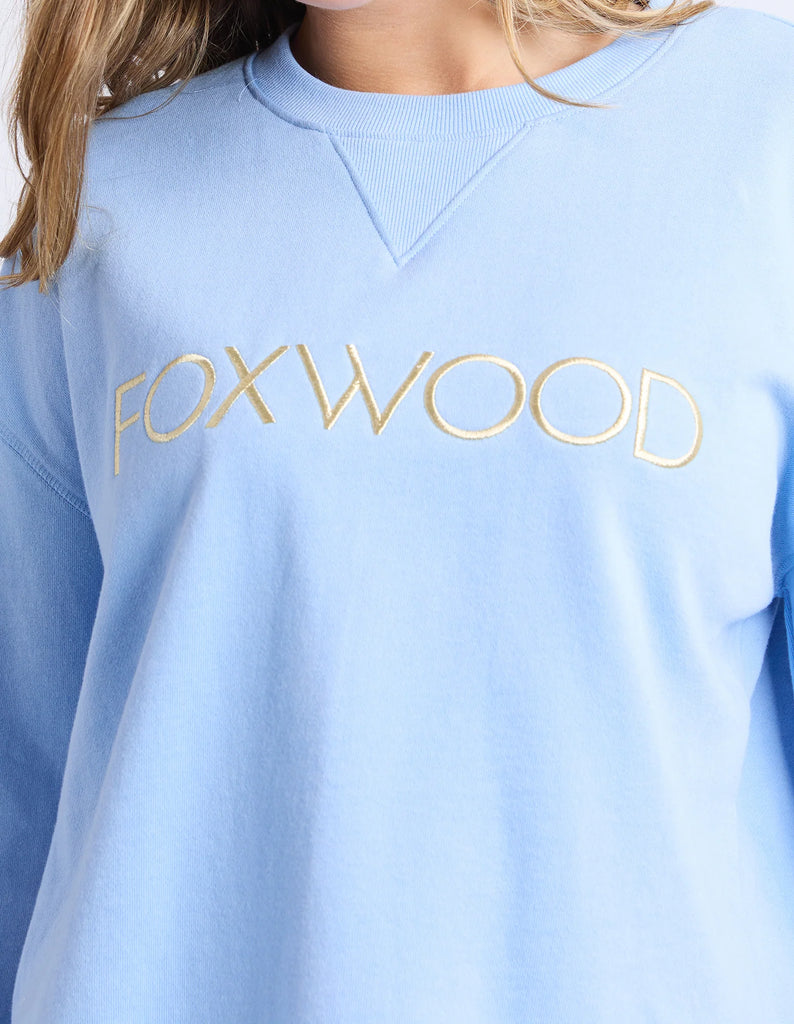 Simplified Metallic Crew - Blue/Lemon-Foxwood-The Bling version of our Best Selling Simplified Crew. This crew is the perfect throw over for your everyday wardrobe. With its round neck, hi-lo hemline, side splits with raw edging & the classic Foxwood logo, you are going to want one in every colour. The Metallic Crew has a stunning lurex thread run through the Foxwood embroidery for that little bit 'extra'. Front chest embroidery Raw edge detail Curved hem 100% Cotton Our model is 176cm and wears Size 10-Pa