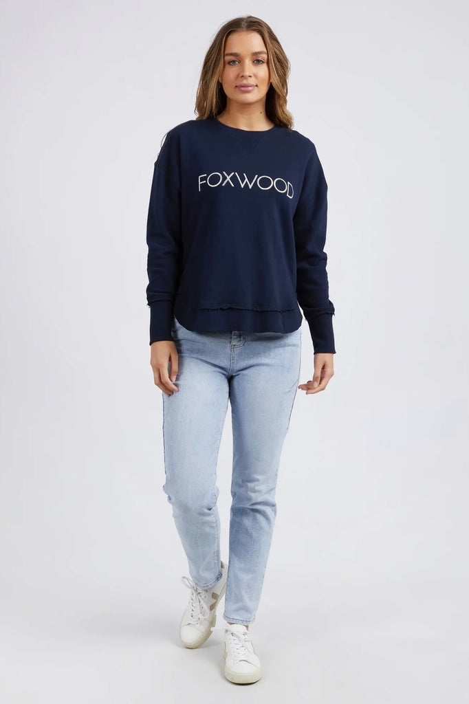 Simplified Metallic Crew - Navy-Foxwood-Say hello to our bling version! If you can't help yourself when it comes to a touch of glitz, then the Metallic Simplified Crew is the perfect addition to your everyday wardrobe. Its round neck, hi-lo hemline, side splits with raw edging and classic Foxwood logo will make you want one in every colour. Everyone loves this best selling crew from Foxwood Clothing. Round crew neckline Classic Foxwood chest logo in lurex metallic thread Side splits Raw edging on cuffs and 
