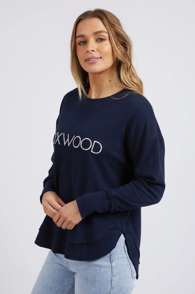 Simplified Metallic Crew - Navy-Foxwood-Say hello to our bling version! If you can't help yourself when it comes to a touch of glitz, then the Metallic Simplified Crew is the perfect addition to your everyday wardrobe. Its round neck, hi-lo hemline, side splits with raw edging and classic Foxwood logo will make you want one in every colour. Everyone loves this best selling crew from Foxwood Clothing. Round crew neckline Classic Foxwood chest logo in lurex metallic thread Side splits Raw edging on cuffs and 