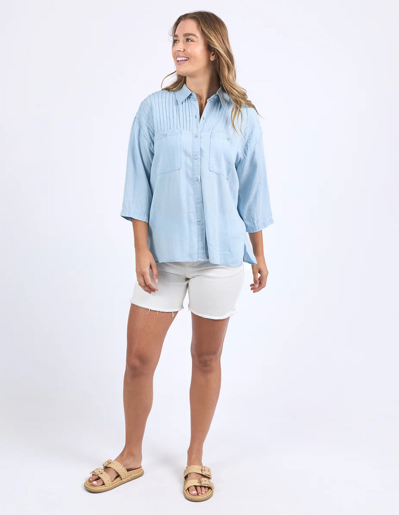 Spire Shirt - Light Blue-Foxwood-Classic with a cool twist. The Spire Shirt features soft textured fabric, pintuck detailing, and a front placket opening with chest pockets for a laid-back yet polished look. Easy to style your way, whether layered, tucked in or worn loose. Front placket opening Pintuck detail Front chest pockets 100% Lyocell Model is wearing a size 10-Pash + Evolve
