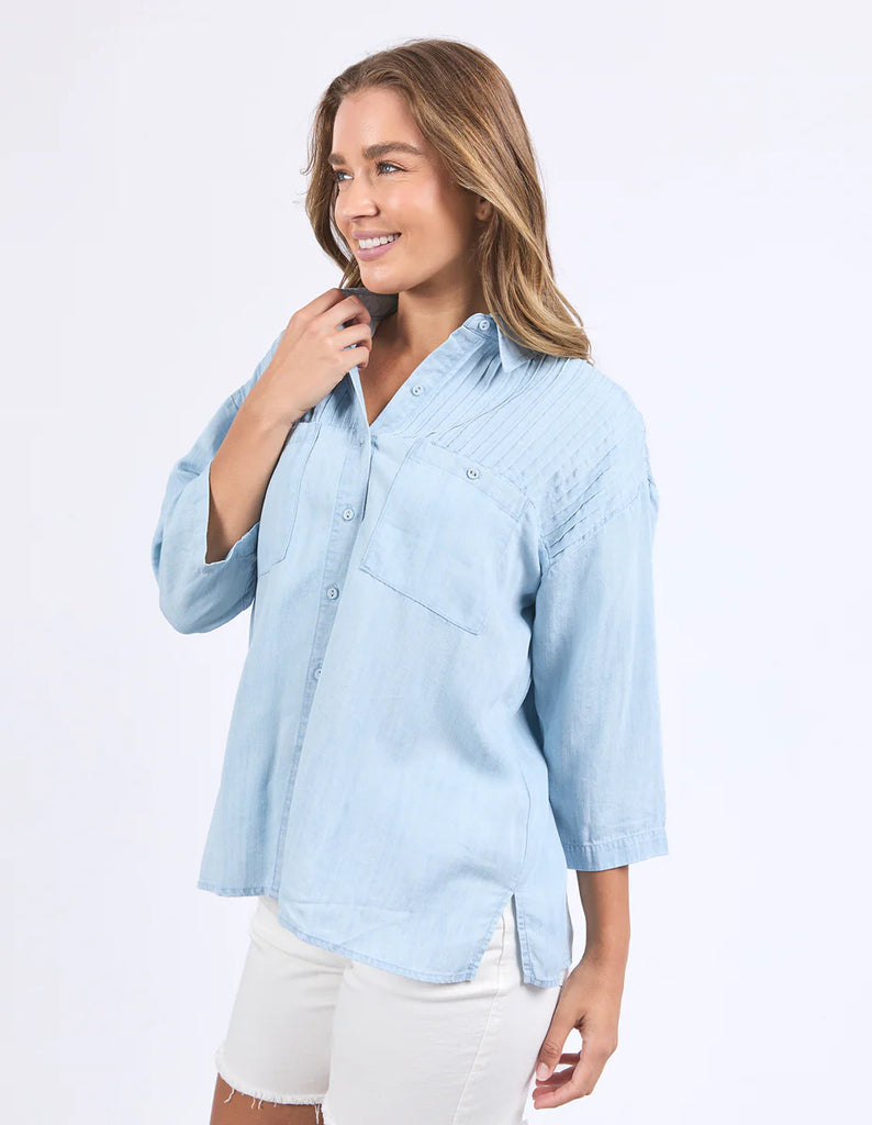 Spire Shirt - Light Blue-Foxwood-Classic with a cool twist. The Spire Shirt features soft textured fabric, pintuck detailing, and a front placket opening with chest pockets for a laid-back yet polished look. Easy to style your way, whether layered, tucked in or worn loose. Front placket opening Pintuck detail Front chest pockets 100% Lyocell Model is wearing a size 10-Pash + Evolve