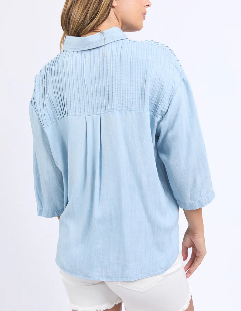 Spire Shirt - Light Blue-Foxwood-Classic with a cool twist. The Spire Shirt features soft textured fabric, pintuck detailing, and a front placket opening with chest pockets for a laid-back yet polished look. Easy to style your way, whether layered, tucked in or worn loose. Front placket opening Pintuck detail Front chest pockets 100% Lyocell Model is wearing a size 10-Pash + Evolve