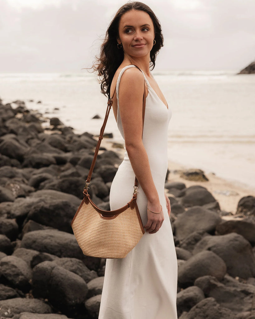 Taya Mini Tote Bag - Raffia/ Tan-Louenhide-The Taya Raffia Tan Mini Tote Bag is a fresh take on summer styling - petite in size, bold in texture, and made for days under the sun. Crafted from natural raffia and contrasted with buttery soft vegan leather, this top handle bag features a sleek boat-shaped silhouette that brings structure to a relaxed coastal mood. Designed as a versatile convertible tote, Taya Raffia Tan offers multiple ways to wear her: a short vegan leather top handle for a polished look, or