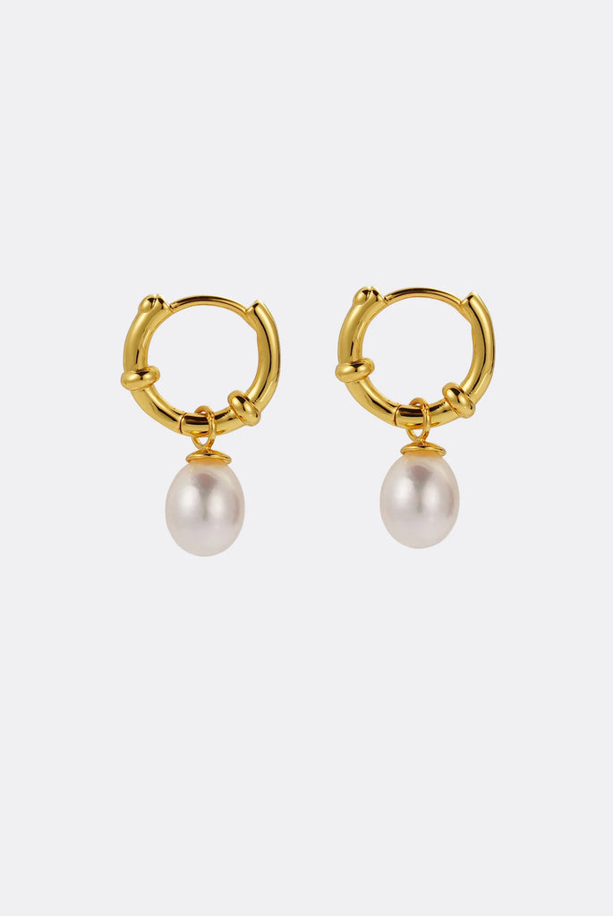 Tessa pearl hoop - gold-Zafino-The Tessa Hoop is a modern take on classic pearl earrings, featuring a polished gold hoop paired with a softly shaped freshwater pearl drop. The clean silhouette makes this piece effortlessly versatile — refined enough for events yet minimal enough for everyday wear. Lightweight and timeless, Tessa adds subtle movement and elegance to any look. Wear alone for understated polish or stack with other hoops and huggies for a layered ear moment. An elevated everyday essential desig