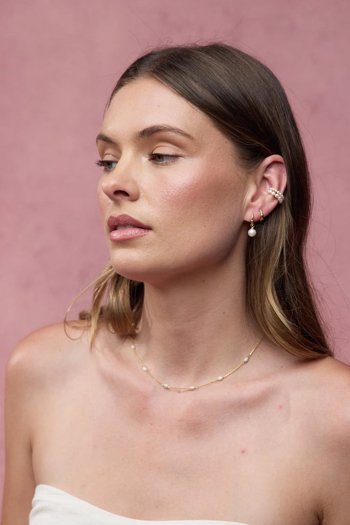 Tessa pearl hoop - gold-Zafino-The Tessa Hoop is a modern take on classic pearl earrings, featuring a polished gold hoop paired with a softly shaped freshwater pearl drop. The clean silhouette makes this piece effortlessly versatile — refined enough for events yet minimal enough for everyday wear. Lightweight and timeless, Tessa adds subtle movement and elegance to any look. Wear alone for understated polish or stack with other hoops and huggies for a layered ear moment. An elevated everyday essential desig