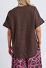 Wander top - coffee-Elm-Easy to wear and beautifully flattering, the Wander Top is designed with a soft V-neckline, centre front pleat and gently curved hem for effortless everyday style. Crafted from a breathable linen blend, it drapes beautifully and pairs perfectly with denim, relaxed linen pants or the matching Wander Pant. V neckline Pleat at centre front Curved hemline Relaxed fit 55% linen 45% viscose The Model is 173cm and is wearing a size 10-Pash + Evolve