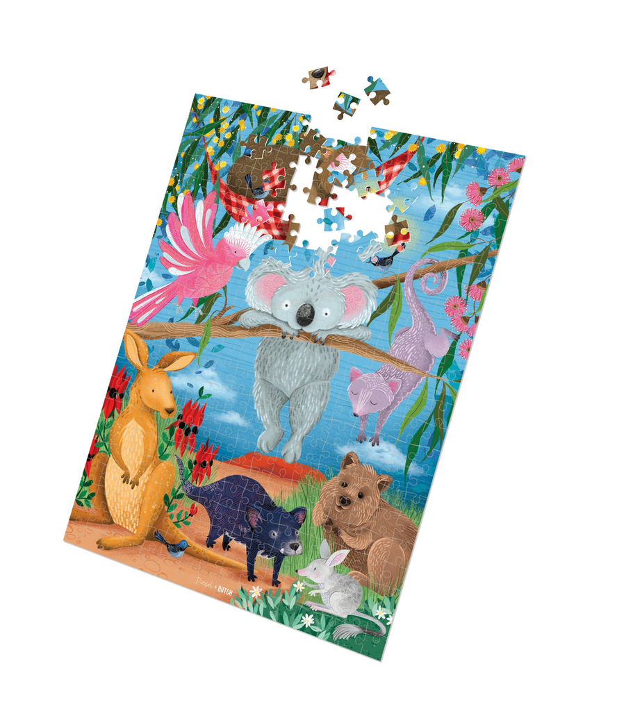 Wildlife down under - 1000pc puzzle-Diesel & Dutch-This vibrant jigsaw illustrates a whimsical Australian wildlife scene filled with lush eucalyptus, bright flowers, and a warm outback landscape. The playful artwork features our most loved native animals engaging in endearing activities with some resting peacefully, hanging from branches, or attentively observing their surroundings. Soft textures, rich colors, and intricate details bring the scene to life, creating a delightful and engaging puzzle. Designin
