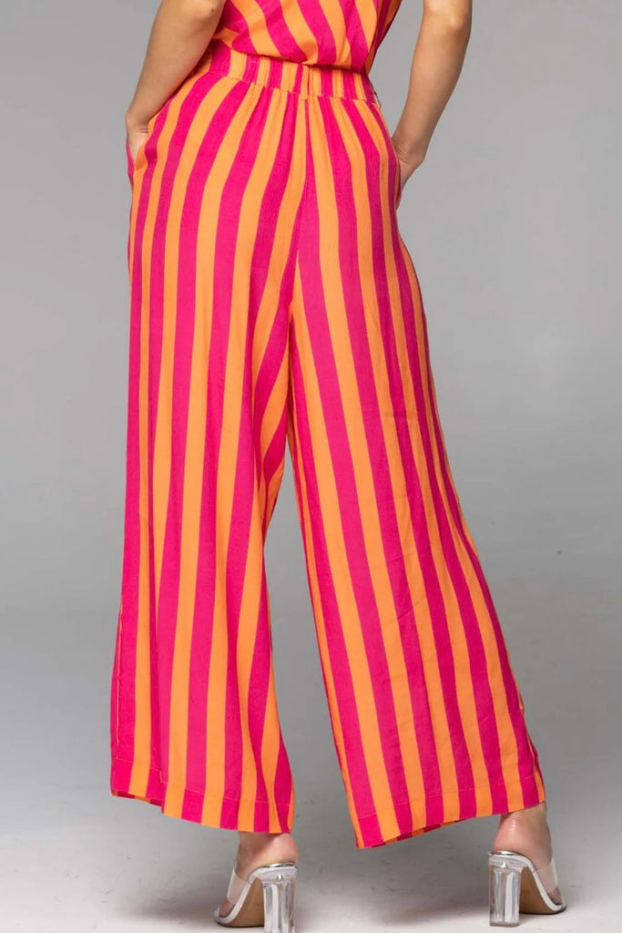 Wonderland wide leg pant - pink orange stripe-FATE + BECKER-Discover the Wonderland Wide Leg Pant, a versatile statement piece that effortlessly adapts to the occasion Crafted with a high-waisted design, these pants exude a refined and flattering silhouette. The wide-leg profile adds an element of timeless style, allowing you to effortlessly dress them up or down to suit any occasion. With practical side pockets and a fly front concealed tab closure, these pants offer both elegance and convenience. The Wond