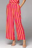 Wonderland wide leg pant - pink orange stripe-FATE + BECKER-Discover the Wonderland Wide Leg Pant, a versatile statement piece that effortlessly adapts to the occasion Crafted with a high-waisted design, these pants exude a refined and flattering silhouette. The wide-leg profile adds an element of timeless style, allowing you to effortlessly dress them up or down to suit any occasion. With practical side pockets and a fly front concealed tab closure, these pants offer both elegance and convenience. The Wond