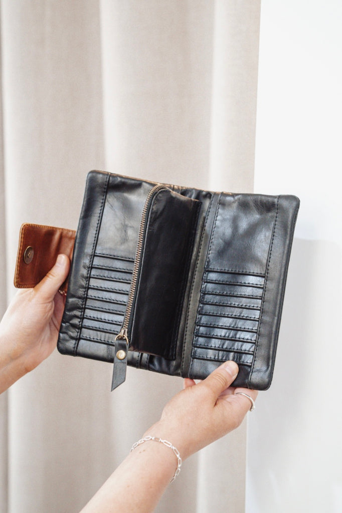Zuri 2 tone wallet - Black with vintage tan-Baleka Leather-Bold design meets everyday functionality with the Zuri 2-Tone Wallet. Featuring striking two-tone detailing, this modern classic adds a pop of personality to your essentials. The press-stud closure opens to reveal a smart interior, including a mini coin purse, 4 note dividers, and 18 card slots — giving you plenty of space to stay organized in style. Chic yet practical, the Zuri Wallet is perfect for those who love a statement accessory that balance