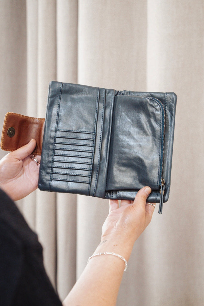 Zuri 2 tone wallet - Navy blue with vintage tan-Baleka Leather-Bold design meets everyday functionality with the Zuri 2-Tone Wallet. Featuring striking two-tone detailing, this modern classic adds a pop of personality to your essentials. The press-stud closure opens to reveal a smart interior, including a mini coin purse, 4 note dividers, and 18 card slots — giving you plenty of space to stay organized in style. Chic yet practical, the Zuri Wallet is perfect for those who love a statement accessory that bal